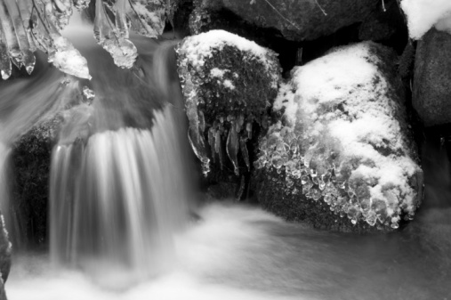 Waterfall, snow and natural ice creations in black and white