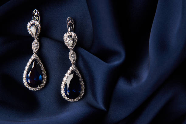 istock Two Golden sapphire earrings with small diamonds 954397182