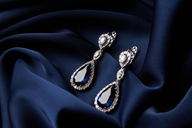 two golden sapphire earrings with small diamonds - gold earring imagens e fotografias de stock