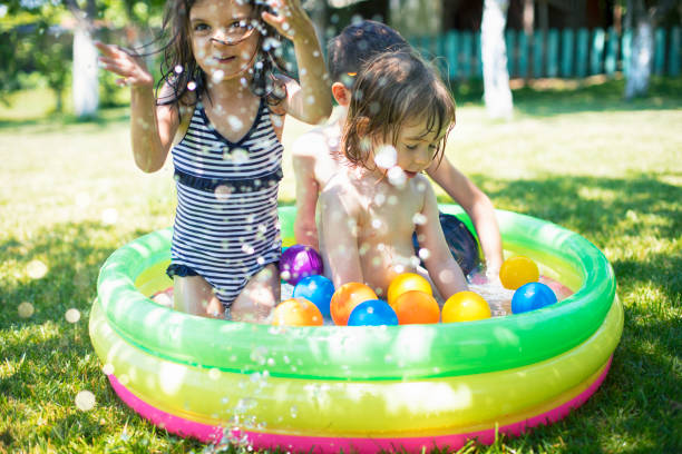 istock Two children having fun in inflatable swimming pool 954397834
