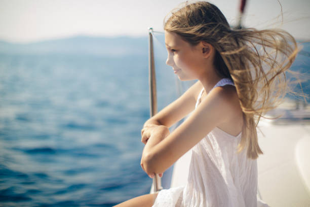 istock Girl enjoying on yacht while sailing 954398028