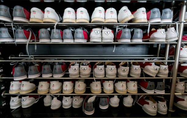istock Close up of bowling shoe rack with different size shoes 954411440