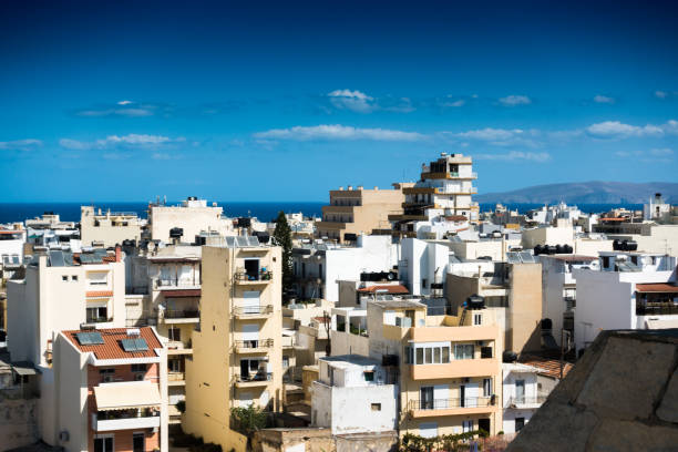 Residential buildings and sea against cloudy sky, Heraklion, Greece