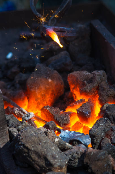 istock blacksmith furnace with burning coals, tools, and glowing hot metal workpieces 954419938