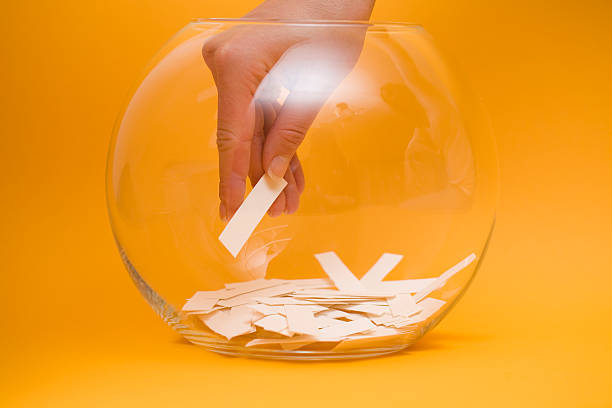 istock Hand reaching into a bowl to pick a lottery ticket 95442269