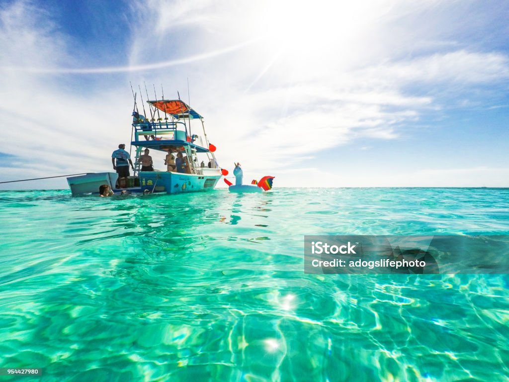 Party Boat in the Caribbean Sea Cozumel, Mexico - April 19, 2018: Group of friends relaxing together on a party boat tour of the Carribean Sea Nautical Vessel Stock Photo