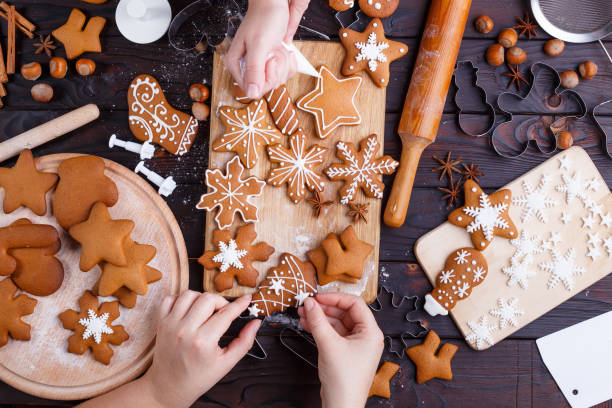 istock Cooking Christmas gingerbread. Friends decorating freshly baked 954428608