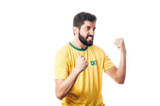 istock Brazilian soccer player celebrates on white background 954432618