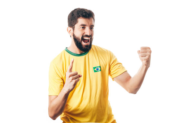 istock Brazilian soccer player celebrates on white background 954432656