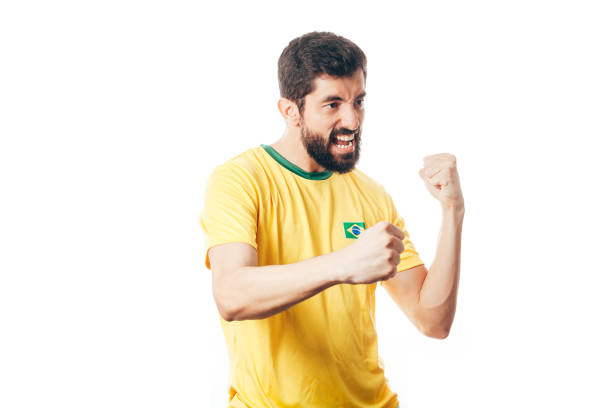 istock Brazilian soccer player celebrates on white background 954432668