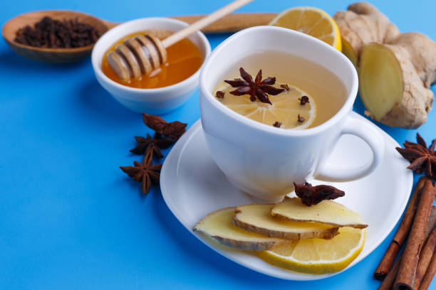 istock Hot warming ginger tea in white cup with a fine slice of lemon, 954441674