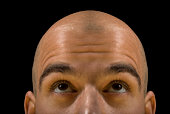 A bald man looking like he is thinking