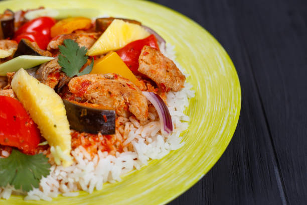 istock Pan-Asian food, appetizing spicy rice with chicken, pineapple sl 954443434