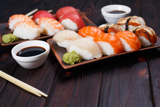 istock Delicious appetizing nigiri sushi, served on clay plates with so 954447516