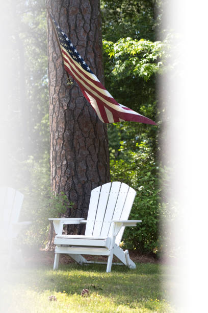 istock White Deck Chairs On Lawn With Fence And American Flag 954448352