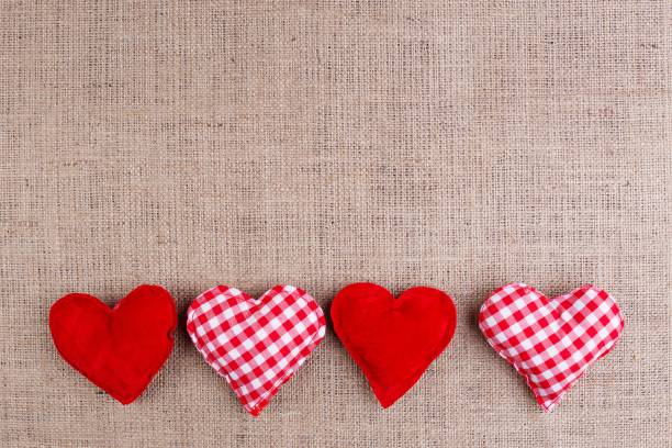 istock Valentines Day background with fabric hearts on sackcloth, copy 954469952