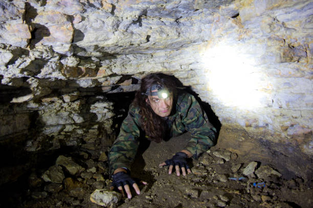 istock Man explores narrow passage in ancient abandoned underground chalky cave monastery 954470154