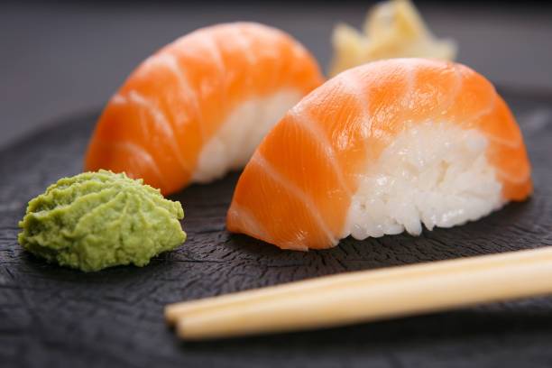 delicious japanese cuisine, nigiri sushi with salmon served with - wasabi imagens e fotografias de stock