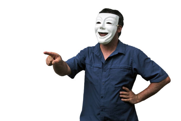 Confident man wearing a happy face mask pointing. Real people. Copy space