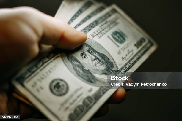 Man Hand With A Stack Of Hundred Us Dollars Bills Close Up Stock Photo - Download Image Now