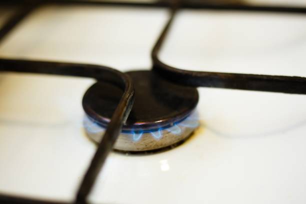 istock Kitchen gas stove with blue flame, close up 954478308