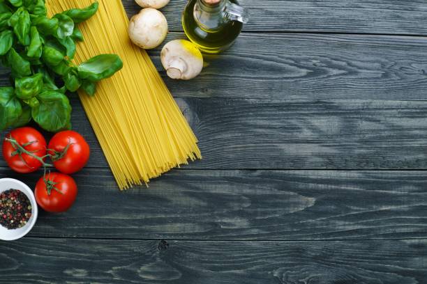 istock Raw spaghetti, tomatoes, basil, olive oil, mushrooms and spices 954487884