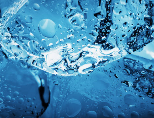 istock Drops on an ice cube shot close-up 954491258