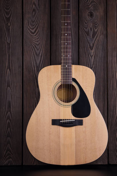 istock Classical acoustic guitar on wooden background 954495466