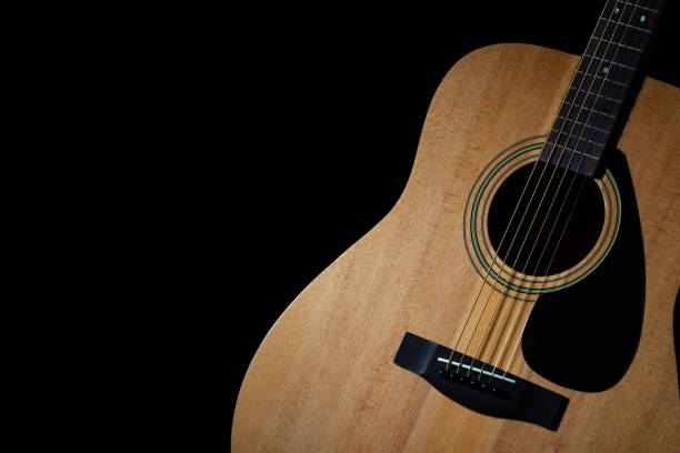 istock Modern acoustic guitar on black background 954495654