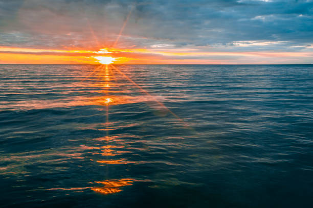 istock Minimalist glowing sunset over calm ocean water 954501450