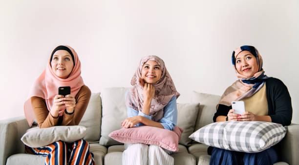 istock Islamic women friends using smart phone and looking up 954501618