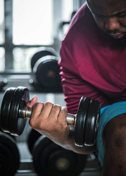 istock Man lifting weights at the gym 954504596