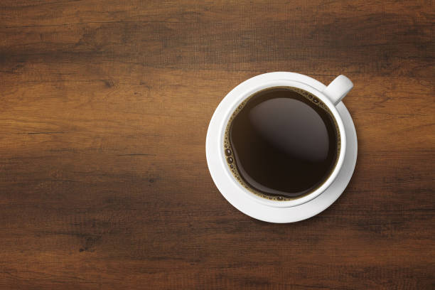 istock white coffee cup and hot espresso coffee on wooden table. top view 954511562