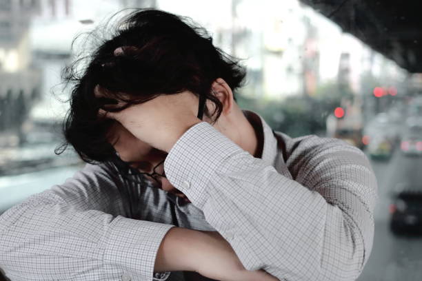 istock Sad stressed young Asian business man touching forehead with hands. 954514244
