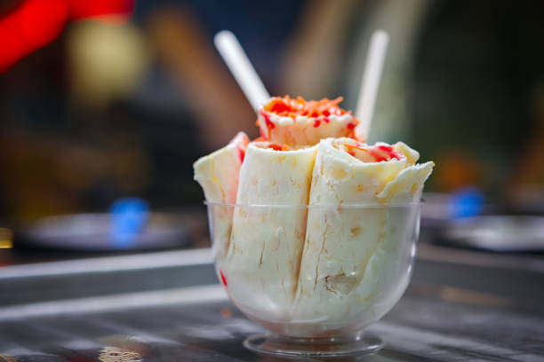 Thai roll ice cream is made by hand on the freezer. Sweet dessert made from natural berries and ingredients.