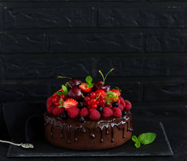 istock Delicious chocolate cake with chocolate icing and fresh berries. 954517972