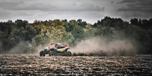 istock Quad bike on plowed field in thick dust 954518372