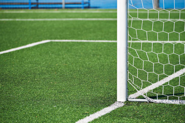 istock Goal post on football field with artificial lawn 954519186