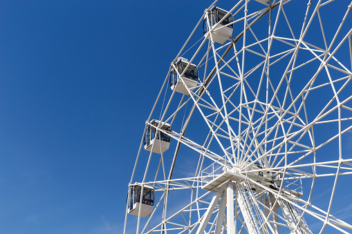 Big wheel against background of blue sky. Copy space
