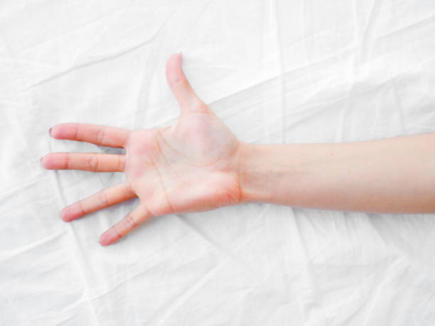 istock female hand on the bed. white sheets. bedroom 954523548