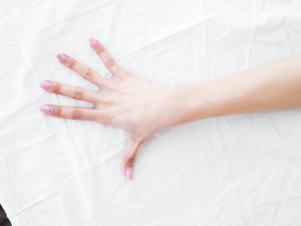 istock female hand on the bed. white sheets. bedroom 954524880