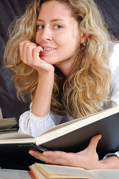 istock young smiling woman surrounded with books 95452535