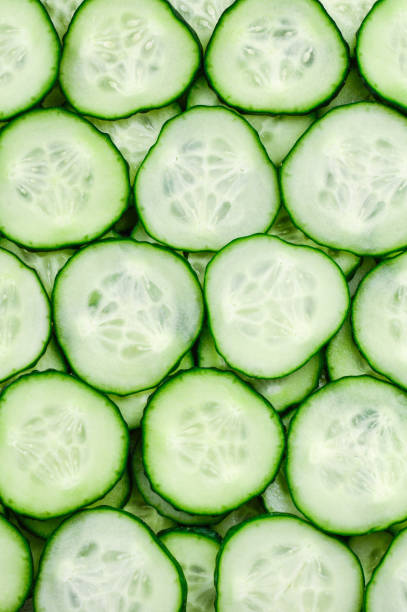 istock Fresh green slices of cucumber as background 954526600
