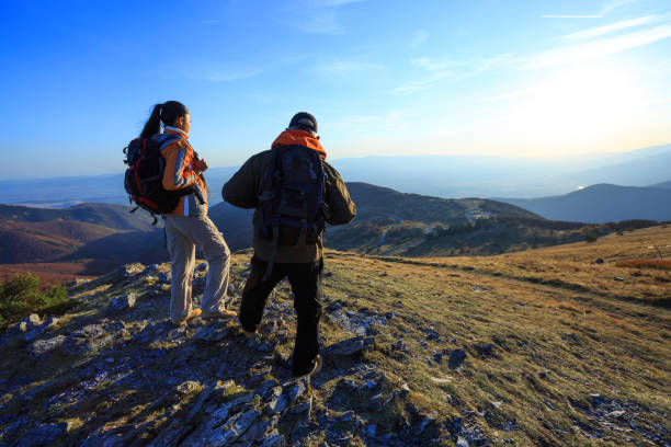 Tourists standing on top mountain and enjoying the view.