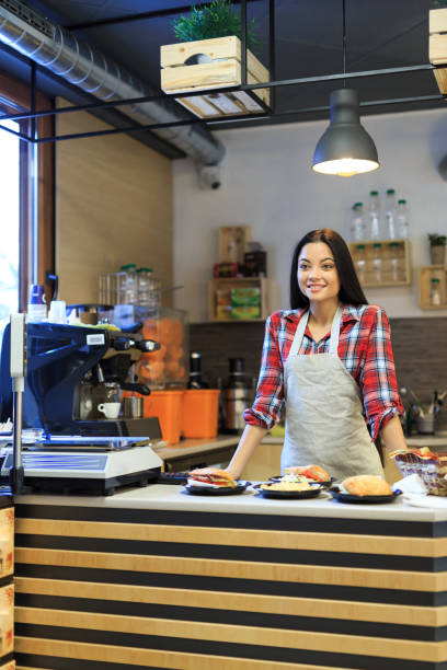 istock Smiling worker in fast food restaurant 954526898