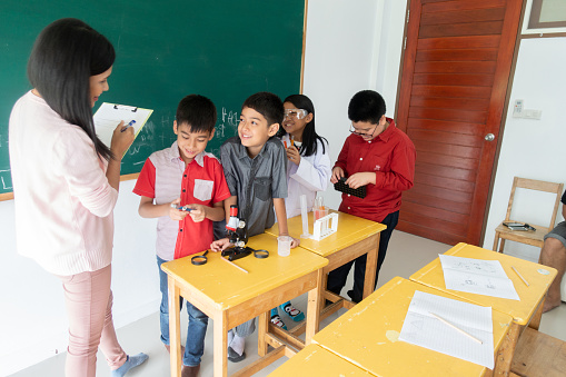 Little students study science in the classroom