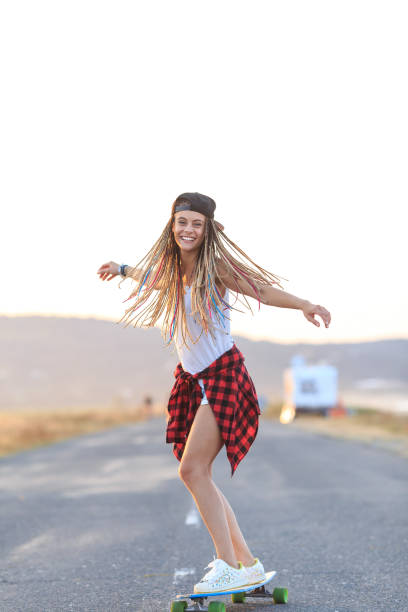 istock Smiling skater moving down on country road 954527078