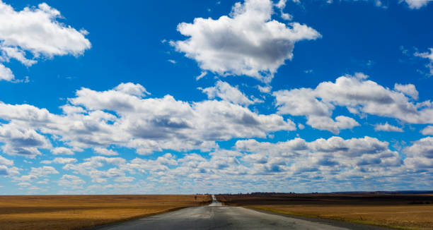 istock Asphalt blurred road and sunlight and blue sky with clouds 954527464
