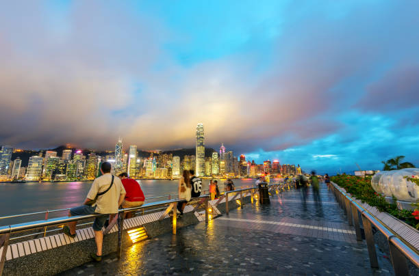HONG KONG , CHINA - JULY. 25 : Travelers visiting the Tsim Sha Tsui Promenade (Avenue of the Stars) on July 25, 2013 in Hong Kong. The Avenue of Stars is located along the Victoria Harbor in Hong Kong.