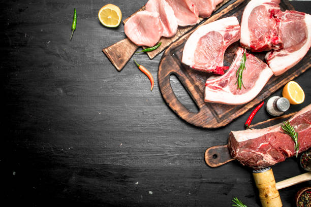 istock Different types of raw pork meat and beef with herb and spices. 954534662